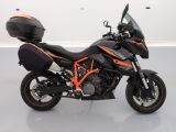 an image of a black and orange motorcycle parked in a room