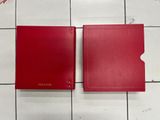 a pair of red folders sitting on top of a tiled floor