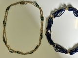 two necklaces on a white surface one is blue and the other is green