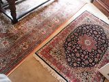 two rugs that are on the floor in the room