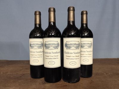 three bottles of wine sitting on top of a wooden table