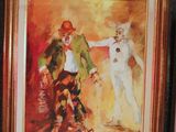 framed painting of a clown and a cat on a wall