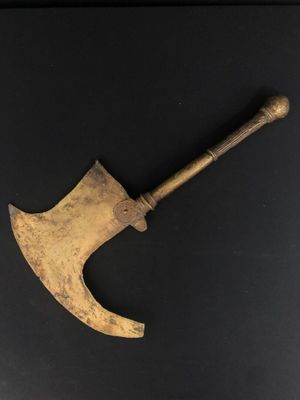 an old axe with a wooden handle on a black surface