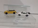 two toy cars that are on display in a glass case