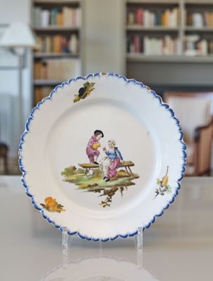 a plate with a picture of a boy and a girl sitting on a bench