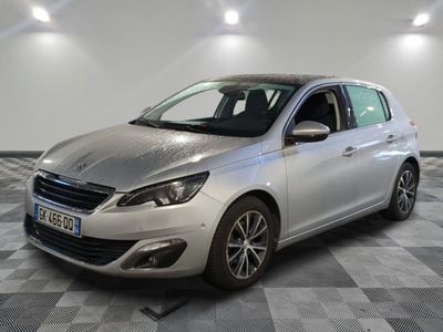 the silver car is parked on a checkered floor in the garage