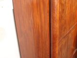 a wooden dresser with a mirror on top of it