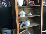 a wooden cabinet with a mirror and vases on it