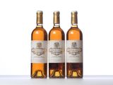three bottles of wine sitting on top of a white table