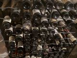 many bottles of wine in a metal rack on the floor