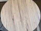 a close up of a wooden table with a black metal base