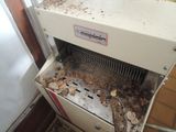 a dirty machine that is sitting in the corner of a room