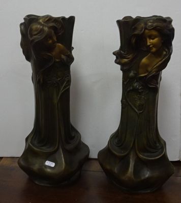 two vases that are sitting on a wooden table