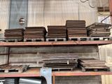 many stacks of wood sitting on a shelf in a warehouse