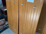 two wooden doors that are next to each other in a room