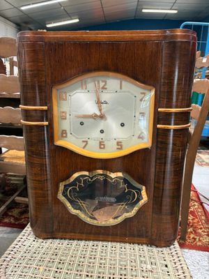 a clock that is sitting on a chair in a room