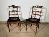 two chairs that are sitting next to each other on a tile floor