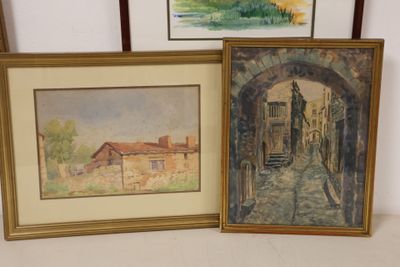 two framed paintings of buildings and a doorway in a room