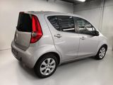 the back of a small silver car parked in a garage