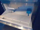 an open refrigerator door with a blue handle on it