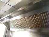an image of a stainless steel exhaust hood in a commercial kitchen