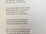an open book with a poem written in french on it