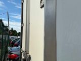 a truck that is parked next to a fence