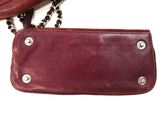 a brown purse with a chain hanging from it