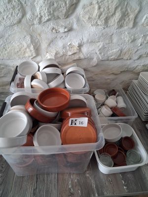 many bowls and cups sitting on a table next to each other