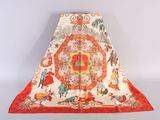 an orange and white blanket with a picture of people and animals on it