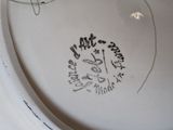 a close up of a plate with writing on it