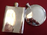 a silver flask with a picture of a woman on it