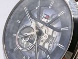a close up of a watch with a brown leather strap