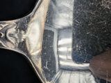 a reflection of a person in a mirror on a spoon