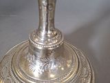 a silver candle that is sitting on a table