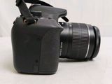 a camera that is sitting on a table with a strap on it