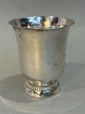 a silver cup that is sitting on a table