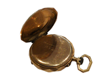 a small gold pocket watch with a chain on it