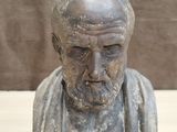 an old bust of a man with a beard sitting on a table
