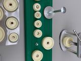 a green board with white buttons on it next to a pair of scissors and a pair of scissors
