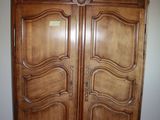 an image of a large wooden armoire in a room