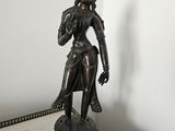 a statue of a woman that is standing on a table