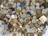 a lot of coins and a bottle of water on the table