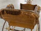a horse pulling a sleigh with a wooden seat