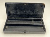 a small black box with compartments on a white surface