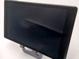 a tablet computer sitting on a stand on a white surface