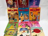 a bunch of cartoon books sitting on top of a white table