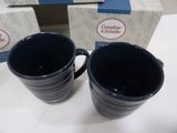 two cups that are sitting next to each other on a table