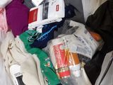 a suitcase filled with clothes and other items on a bed