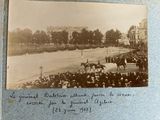 an old photo of a crowd of people watching a horse race